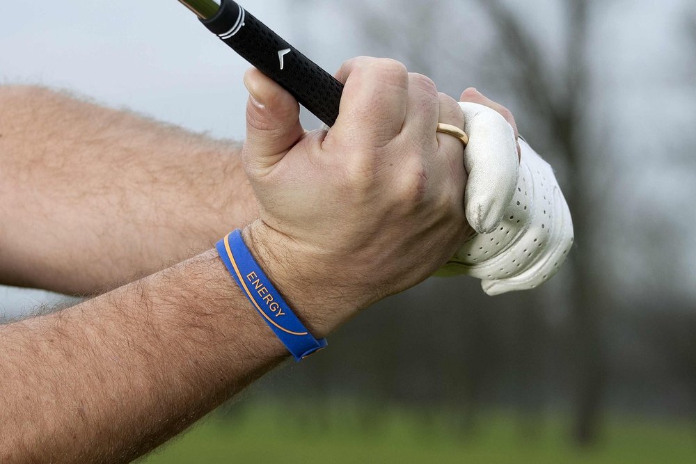 Golfer's gloved hand holding the grip of a club